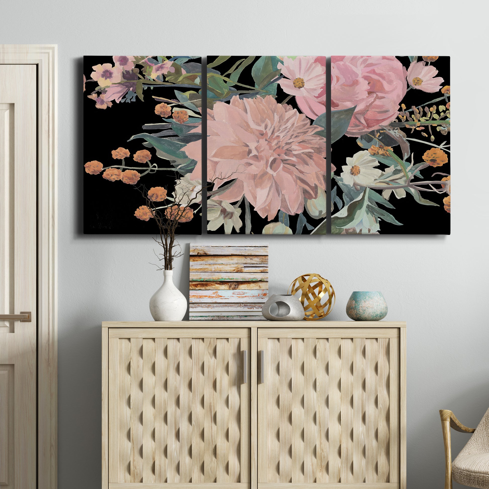 Three-panel canvas wall art featuring dark floral night blossoms, displayed above a cabinet in an entryway.