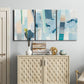Three-panel canvas wall art featuring layered geometric abstract strata forms, displayed above a cabinet in an entryway.
