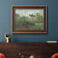 Impressionist garden landscape at Argenteuil by Claude Monet in an ornate bronzed mahogany wood frame displayed in a dark-toned interior setting.