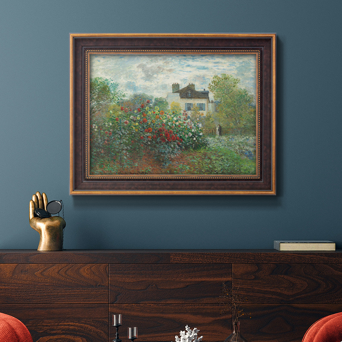 Impressionist garden landscape at Argenteuil by Claude Monet in an ornate bronzed mahogany wood frame displayed in a dark-toned interior setting.