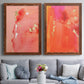 Set of two maple barnwood framed canvas prints depicting paired glamorous fluid abstracts with translucent warm washes, drips, and scattered metallic accents above a sofa in a contemporary living room.