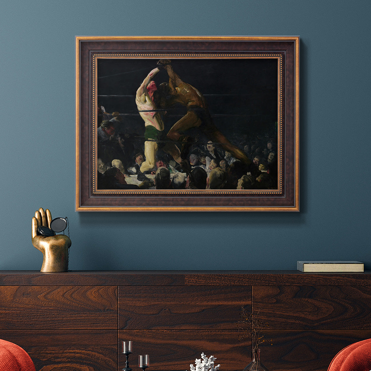 American genre painting of men in a social club by George Bellows in an ornate bronzed mahogany wood frame displayed in a dark-toned interior setting.