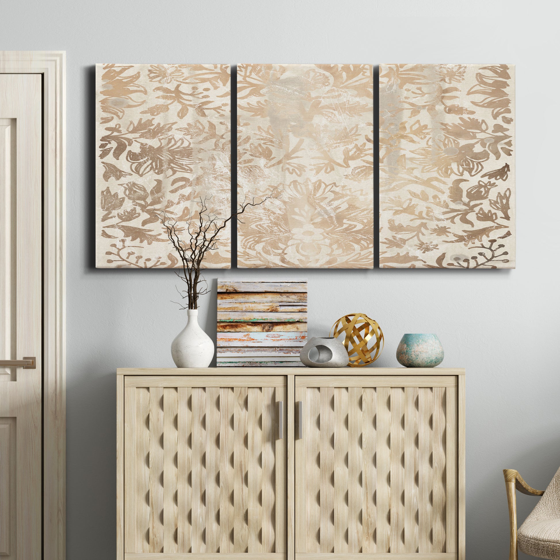 Three-panel canvas wall art featuring ornamental damask abstract pattern, displayed above a cabinet in an entryway.