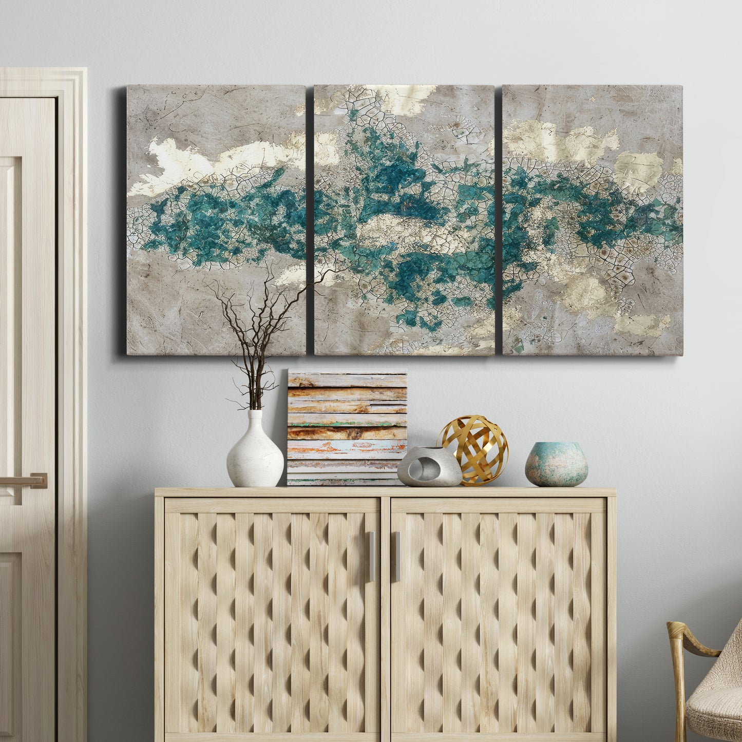 Three-panel canvas wall art featuring layered mineral abstract textures, displayed above a cabinet in an entryway.