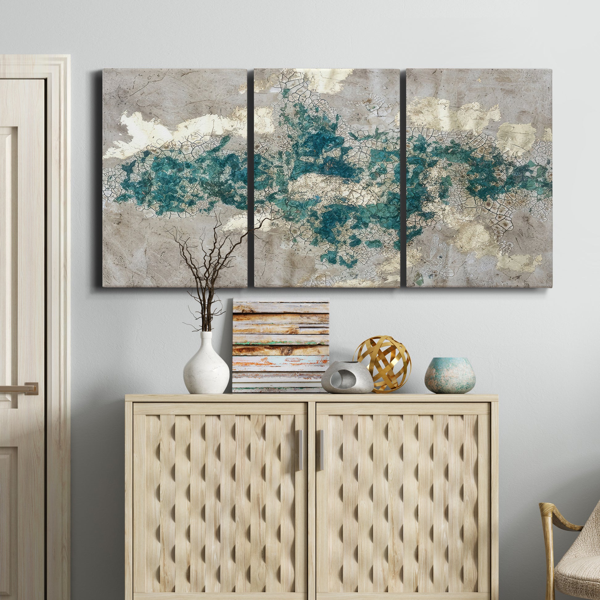 Three-panel canvas wall art featuring layered mineral abstract textures, displayed above a cabinet in an entryway.