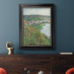 Impressionist landscape view of Vétheuil by Claude Monet in an ornate black frame with gilded inner detail displayed in a dark-toned interior setting.