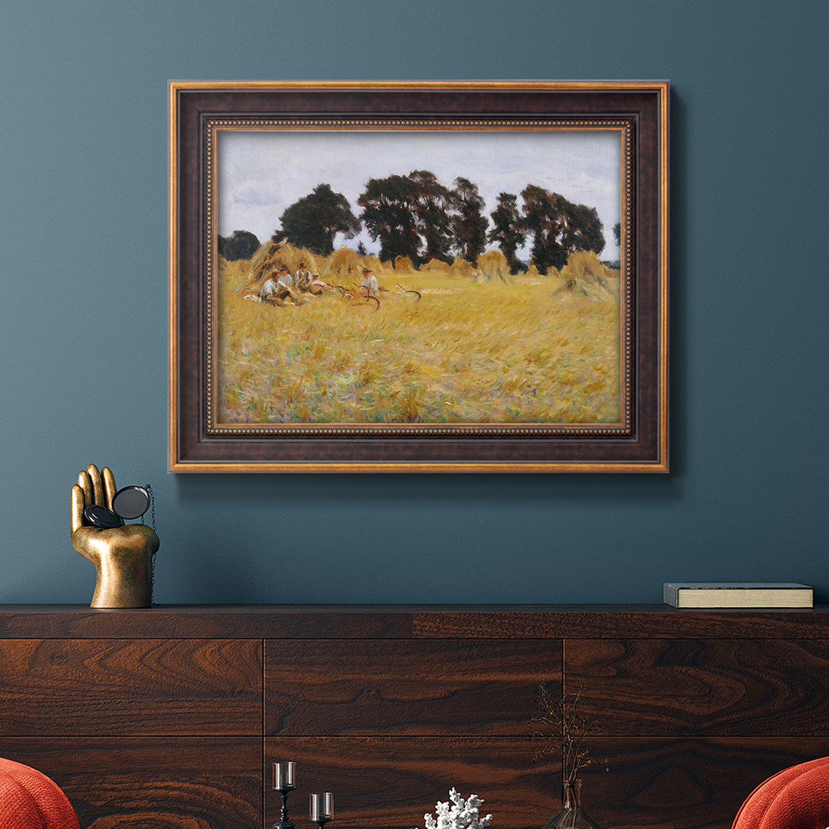 Impressionist rural harvest scene by John Singer Sargent in an ornate bronzed mahogany wood frame displayed in a dark-toned interior setting.