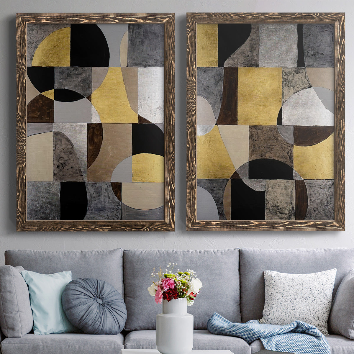 Set of two walnut barnwood framed canvas prints depicting paired structured modern abstracts with semicircles, rectangles, textured panels, and metallic-looking accents above a sofa in a contemporary living room.