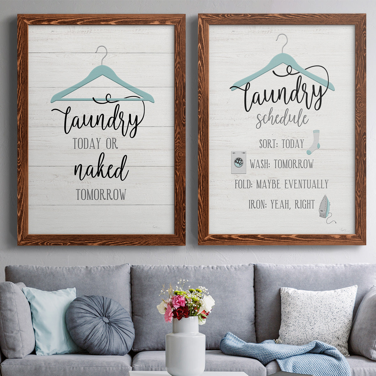 Set of two maple barnwood framed canvas prints depicting paired rustic typographic wall art with hand-lettered phrases, socks hangers and laundry symbols on linen texture above a sofa in a contemporary living room.