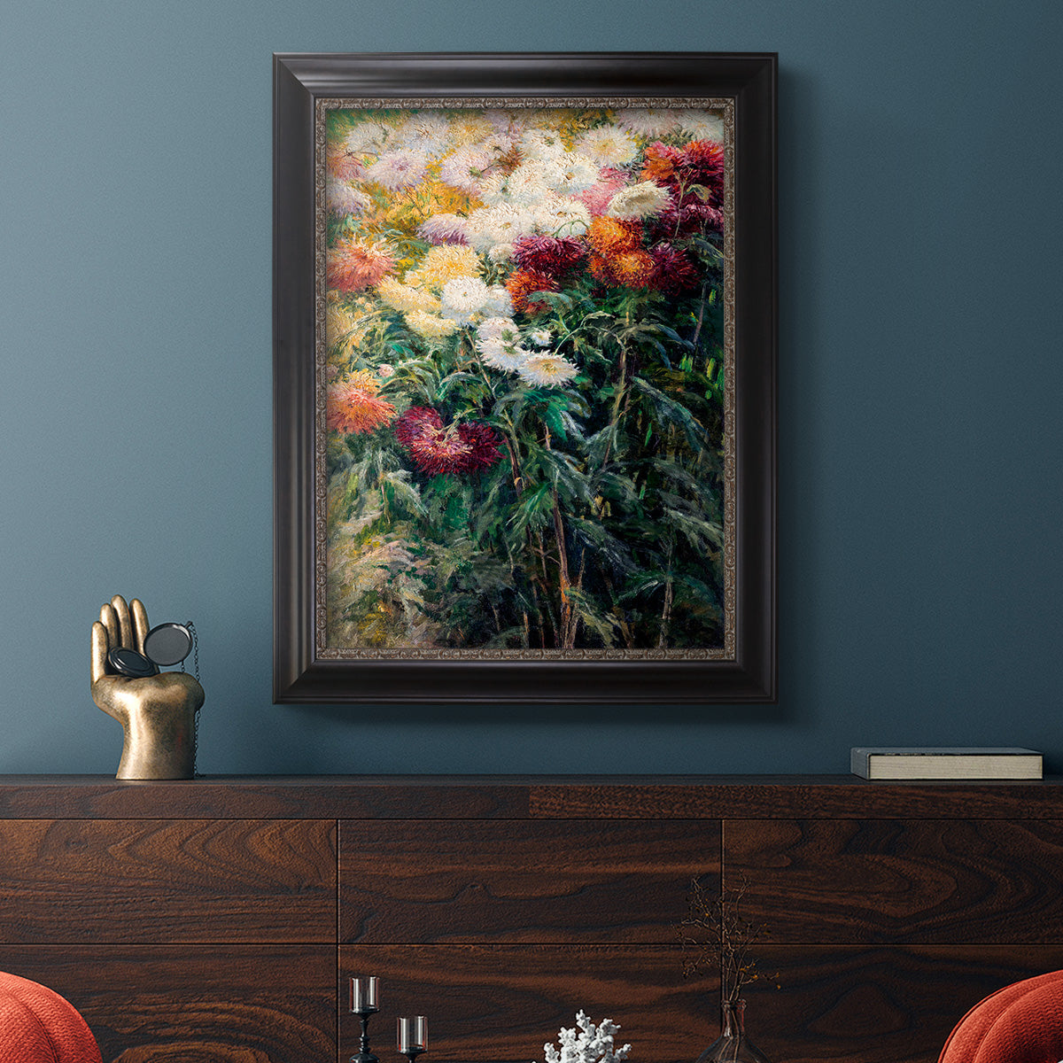 Impressionist garden floral painting by Gustave Caillebotte in an ornate black frame with gilded inner detail displayed in a dark-toned interior setting.