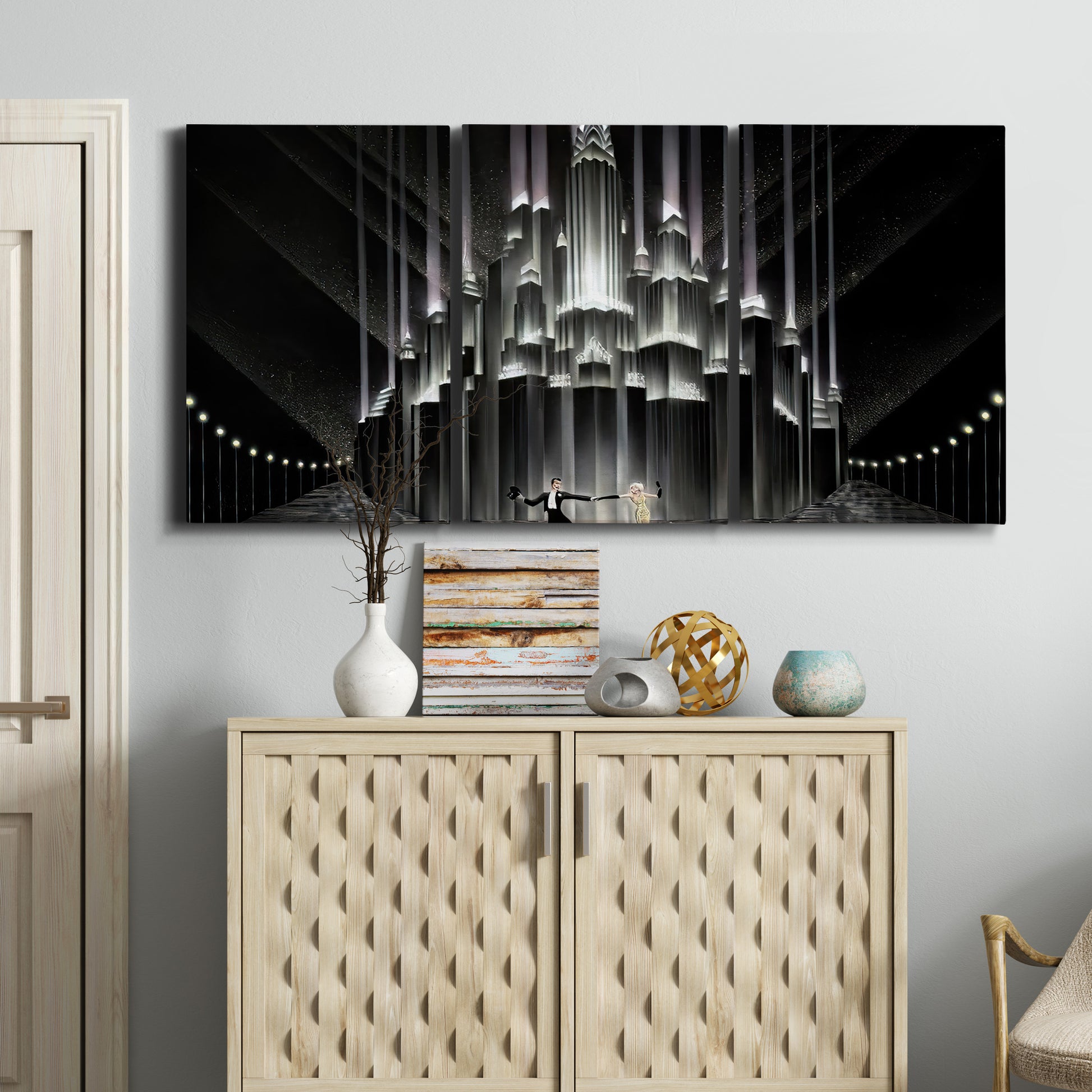 Three-panel canvas wall art featuring vintage city scene with figures, displayed above a cabinet in an entryway.