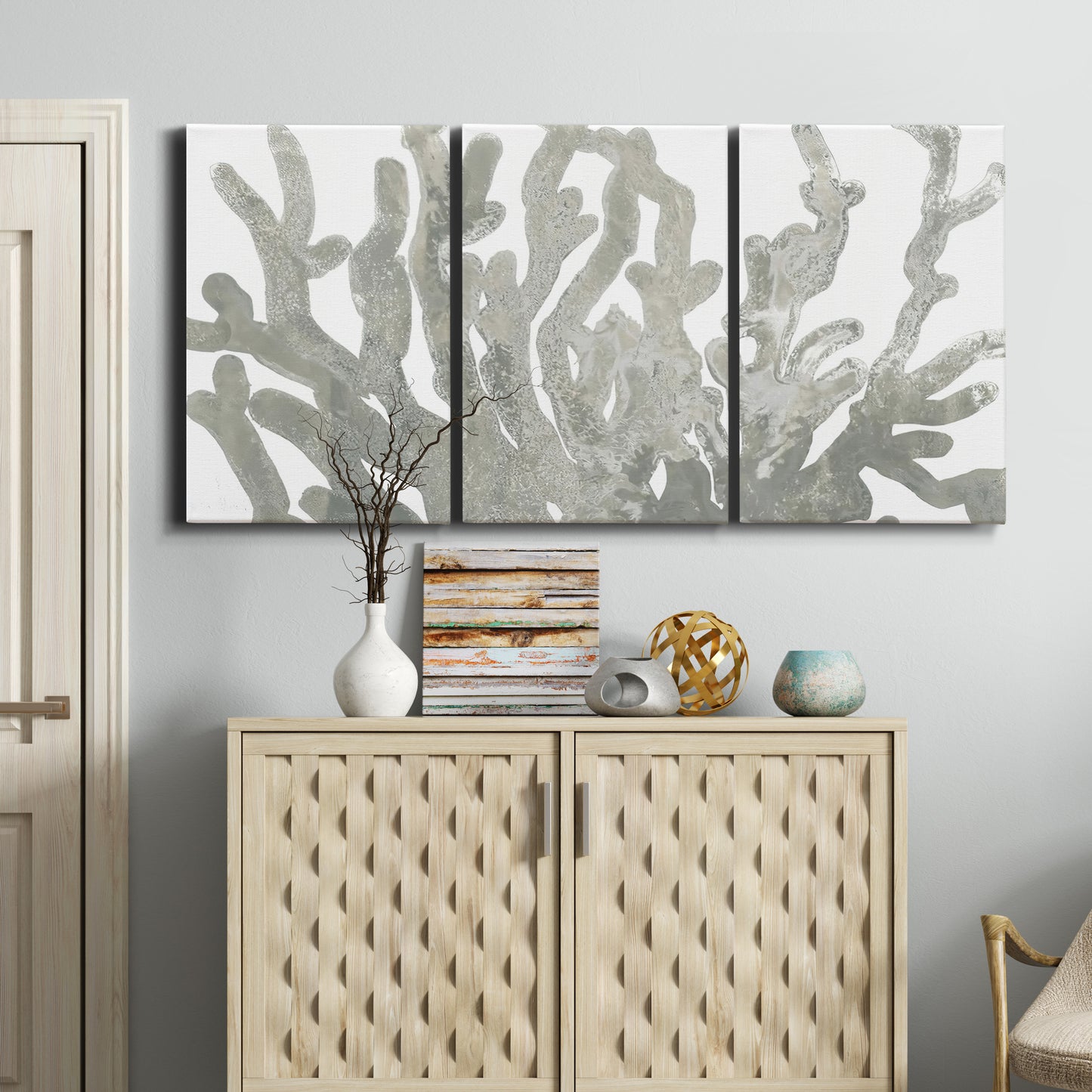 Three-panel canvas wall art featuring monochrome coral texture study, displayed above a cabinet in an entryway.