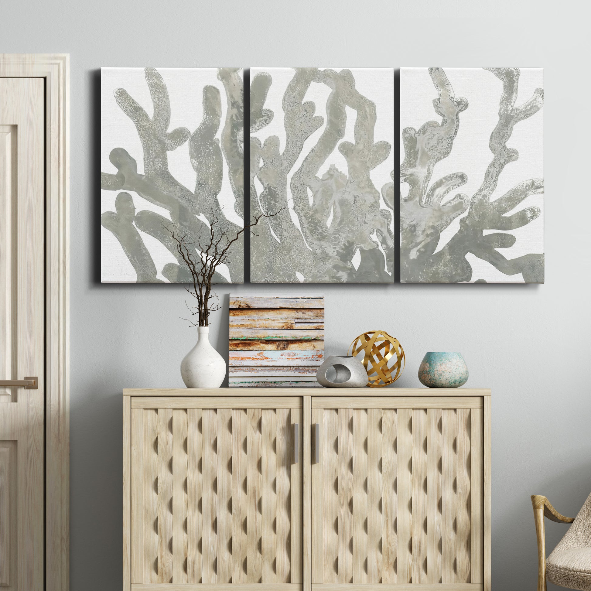 Three-panel canvas wall art featuring monochrome coral texture study, displayed above a cabinet in an entryway.