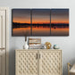 Three-panel canvas wall art featuring glowing sunset over water, displayed above a cabinet in an entryway.