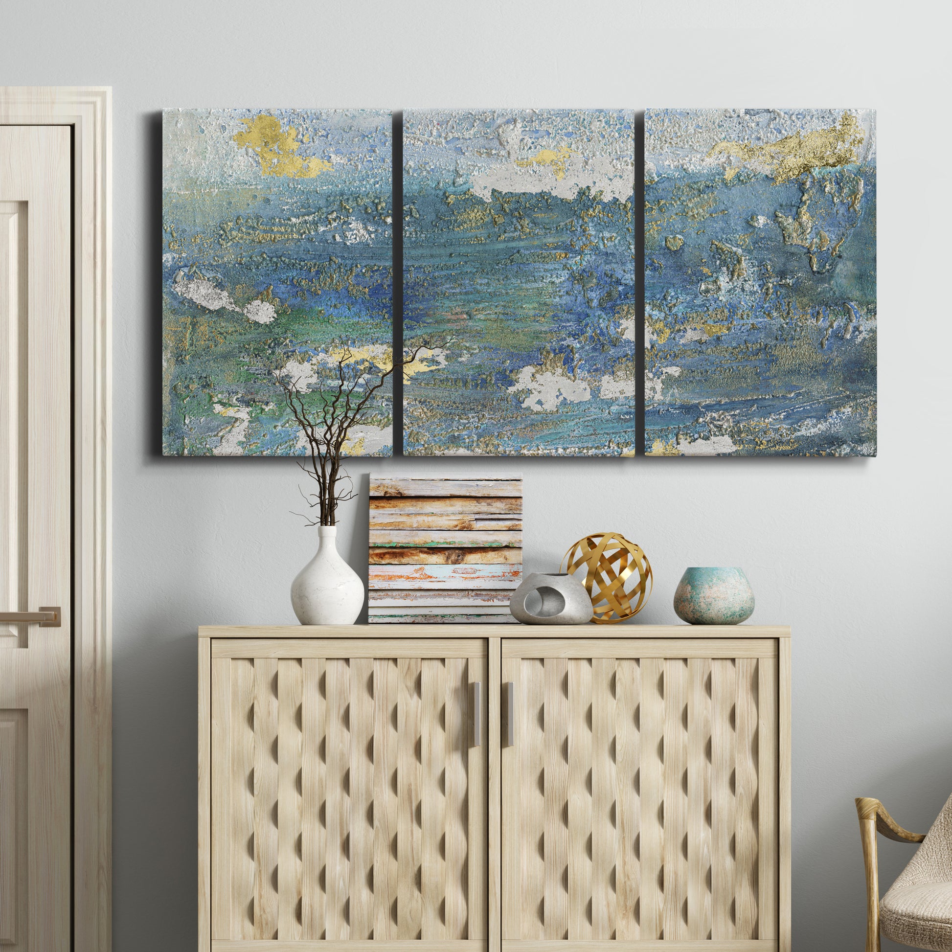 Three-panel canvas wall art featuring sparkling abstract sea surface, displayed above a cabinet in an entryway.
