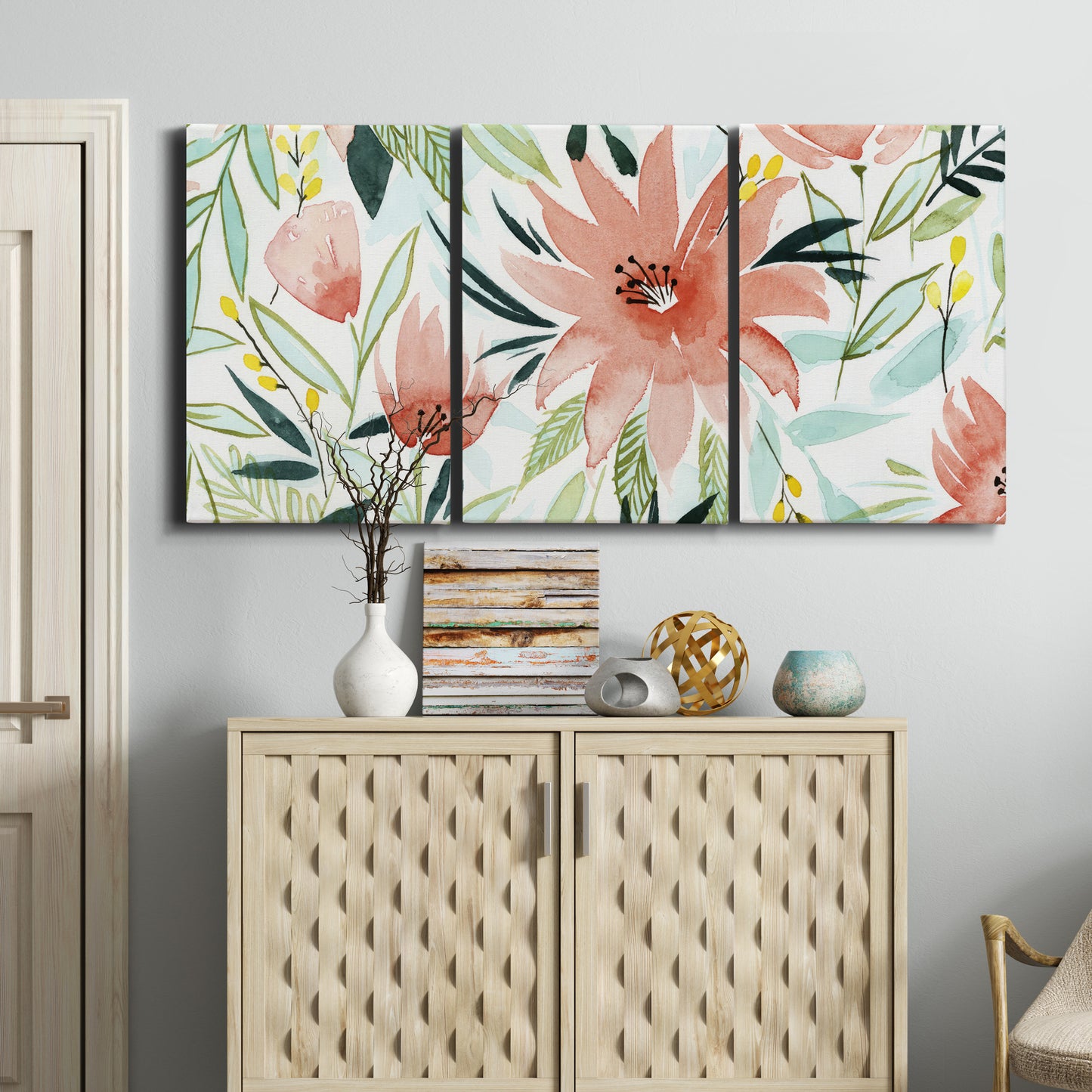 Three-panel canvas wall art featuring tropical botanical collage, displayed above a cabinet in an entryway.
