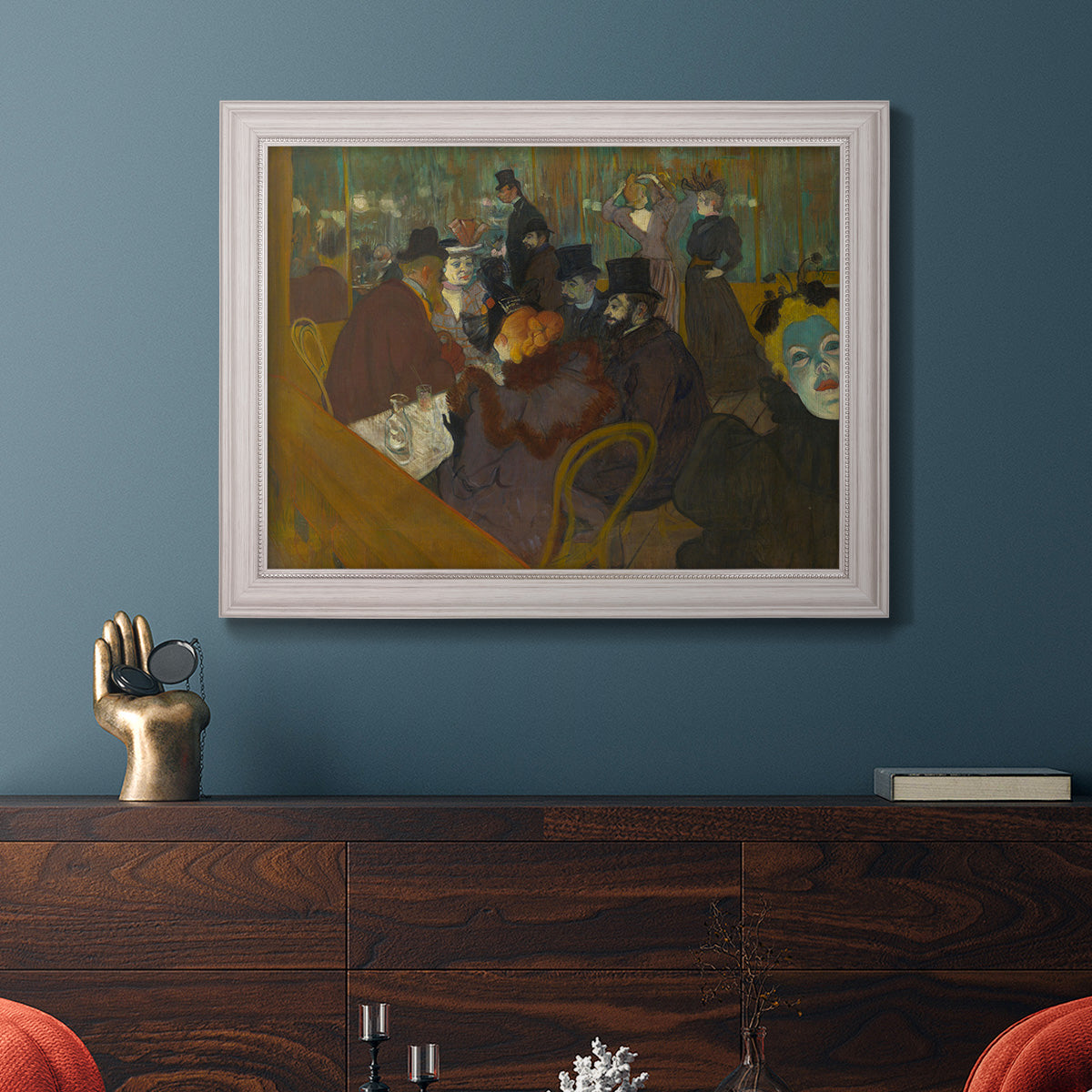 Impressionist cabaret interior scene by Henri de Toulouse-Lautrec in an ornate weathered white frame displayed in a dark-toned interior setting.