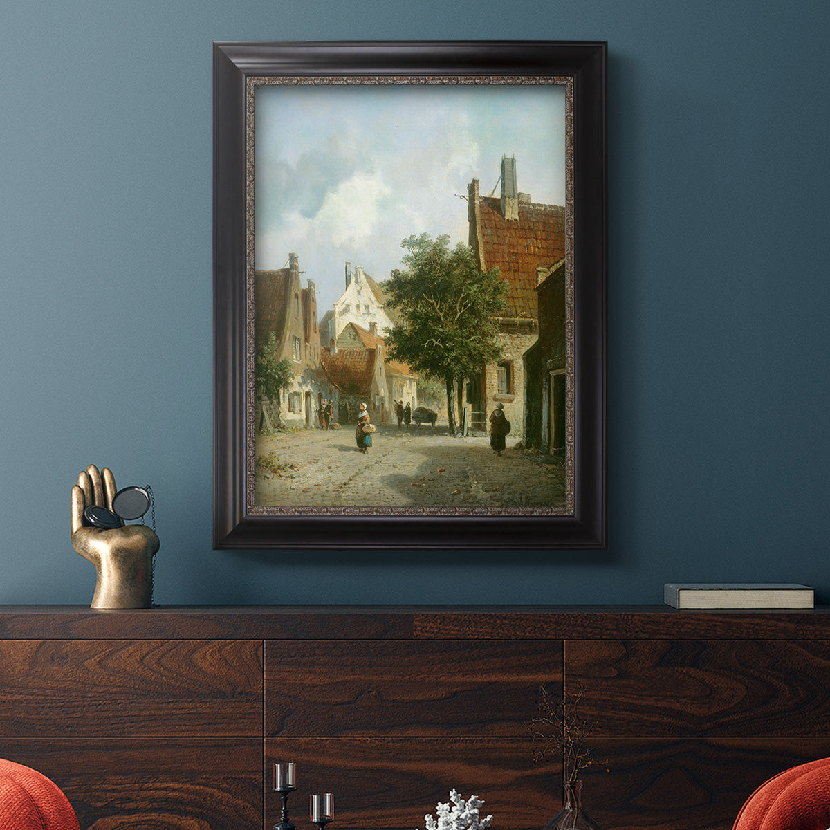 Rustic European street scene painting by Adriaan Eversen in an ornate black frame with gilded inner detail displayed in a dark-toned interior setting.