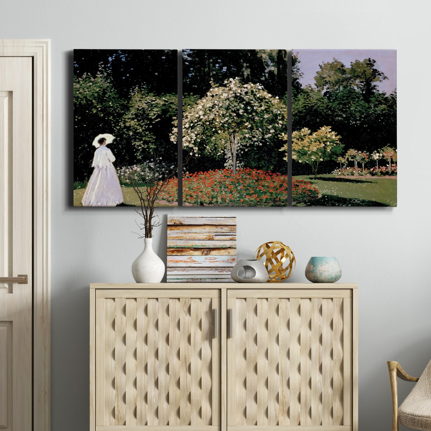 Three-panel canvas wall art featuring woman seated in garden landscape, displayed above a cabinet in an entryway.