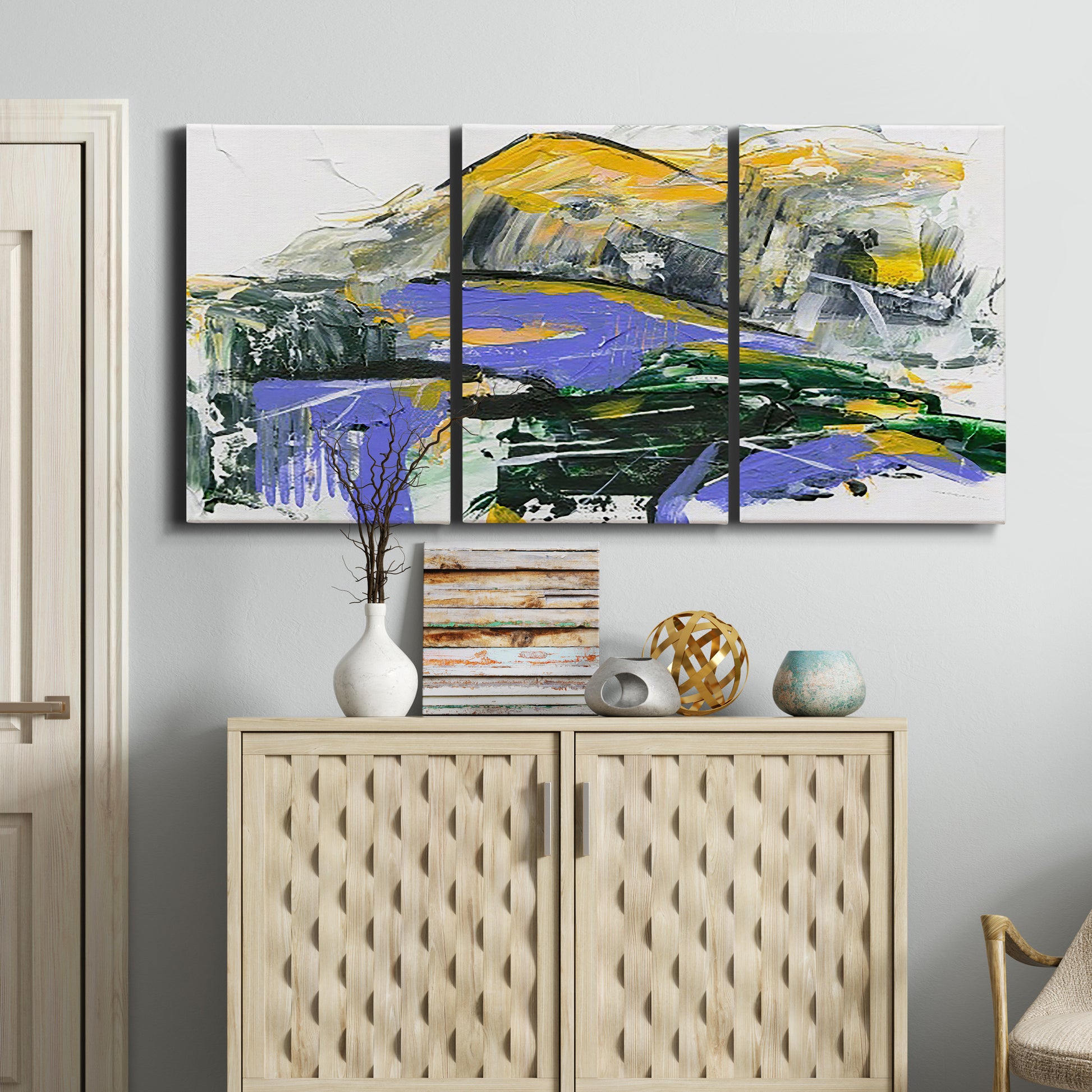 Three-panel canvas wall art featuring quiet abstract mountain silhouette, displayed above a cabinet in an entryway.