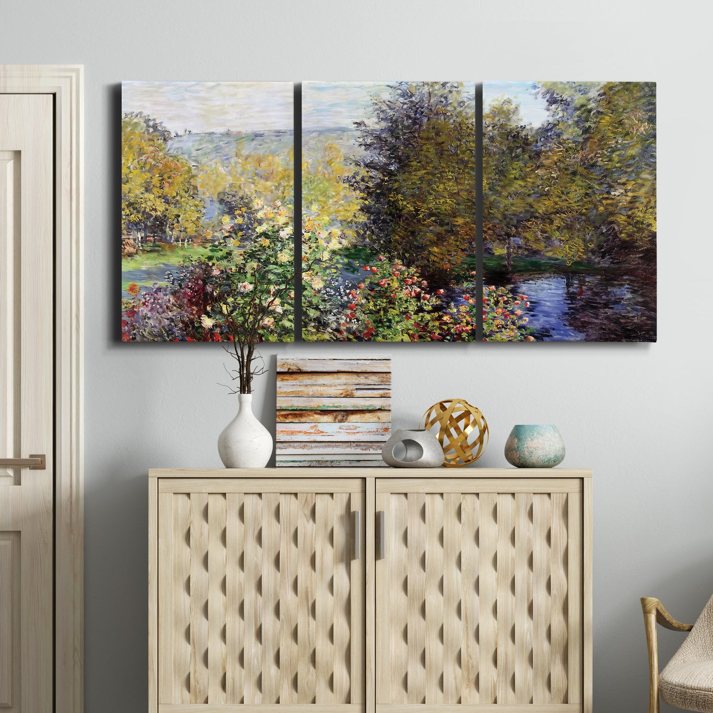 Three-panel canvas wall art featuring garden corner with flowering trees, displayed above a cabinet in an entryway.