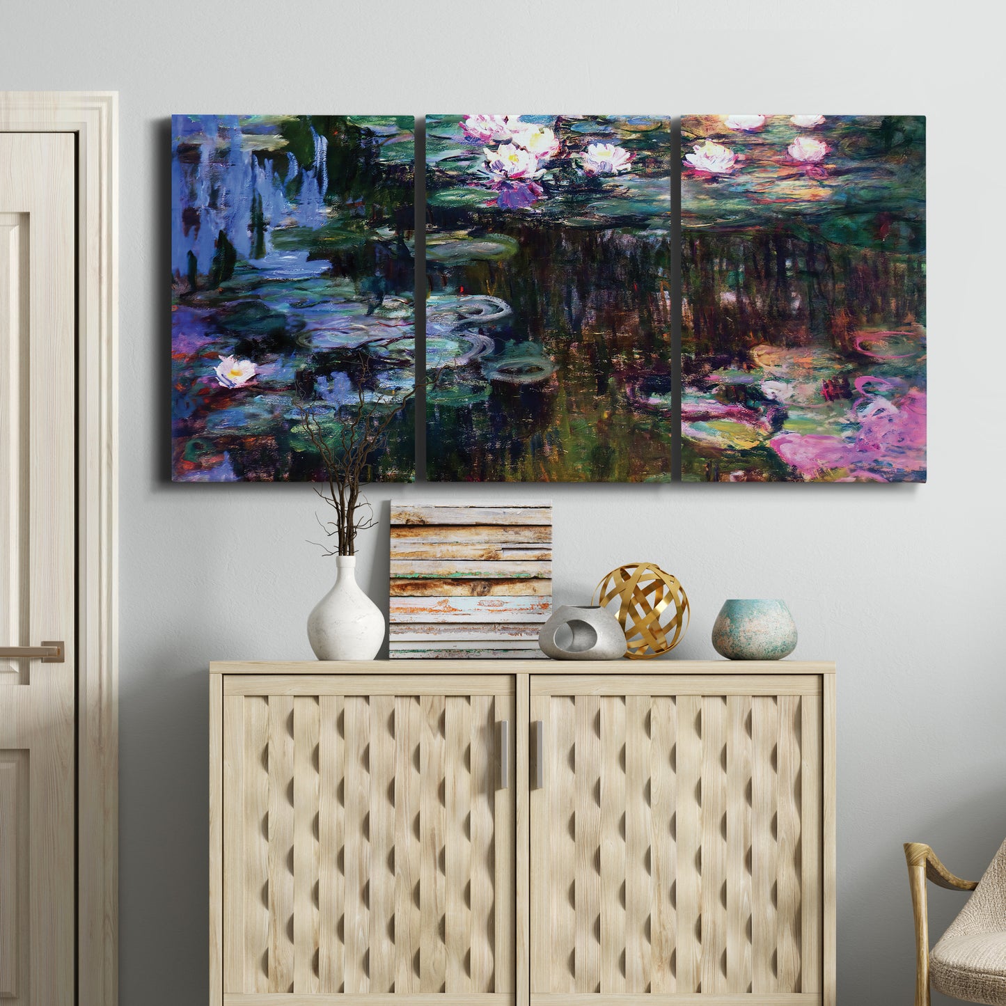 Three-panel canvas wall art featuring water lilies with willow reflections, displayed above a cabinet in an entryway.