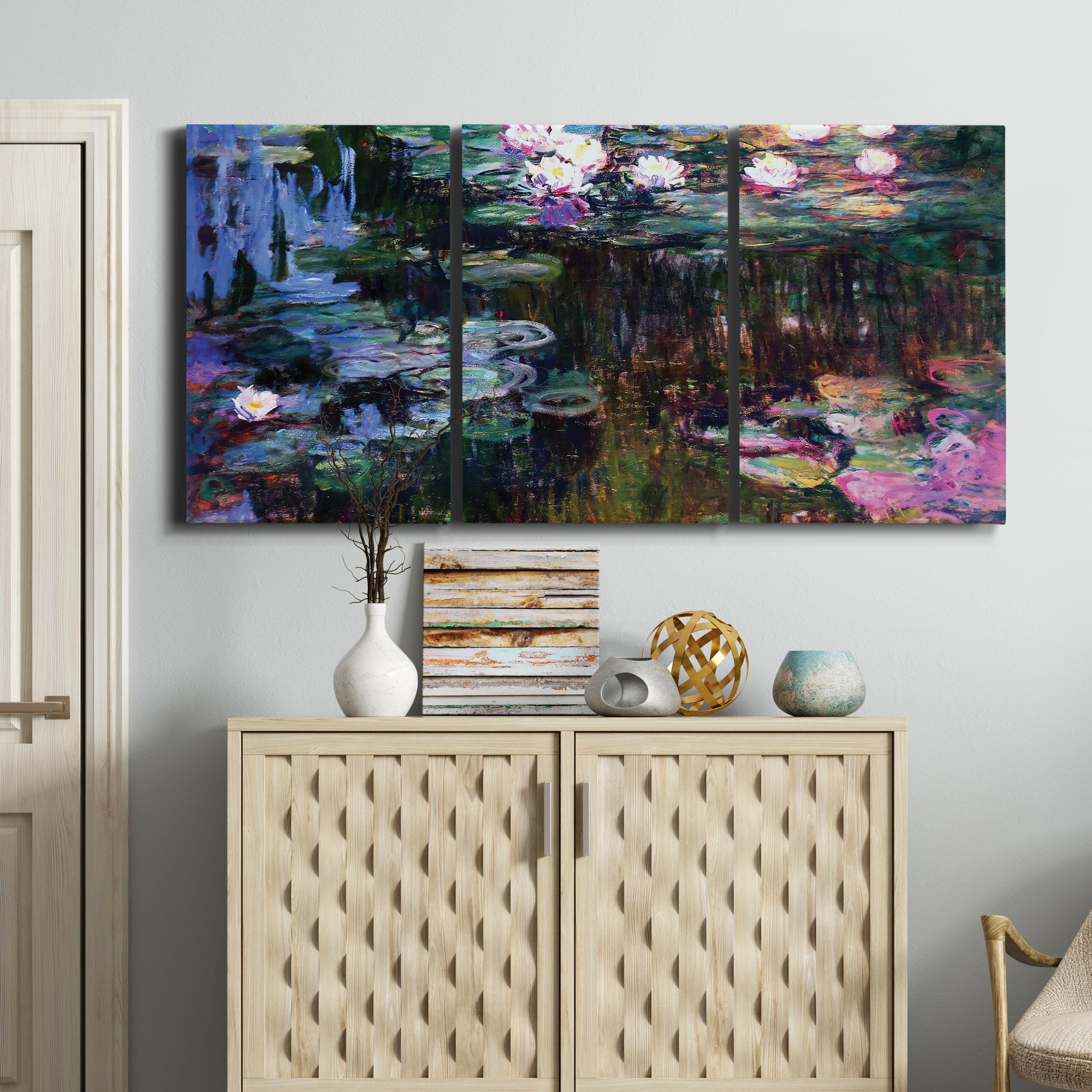 Three-panel canvas wall art featuring water lilies with willow reflections, displayed above a cabinet in an entryway.