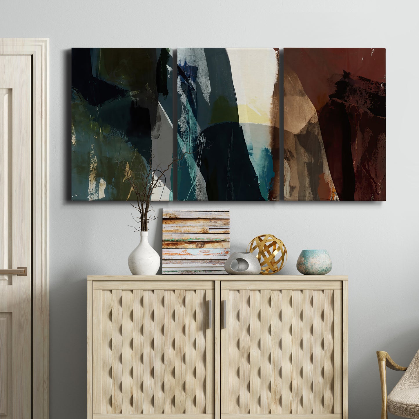 Three-panel canvas wall art featuring layered neutral abstract textures, displayed above a cabinet in an entryway.