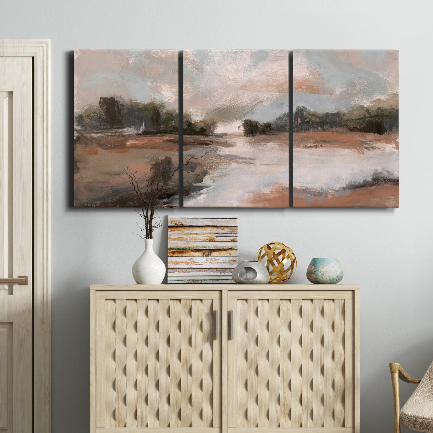 Three-panel canvas wall art featuring quiet pond with soft reflections, displayed above a cabinet in an entryway.