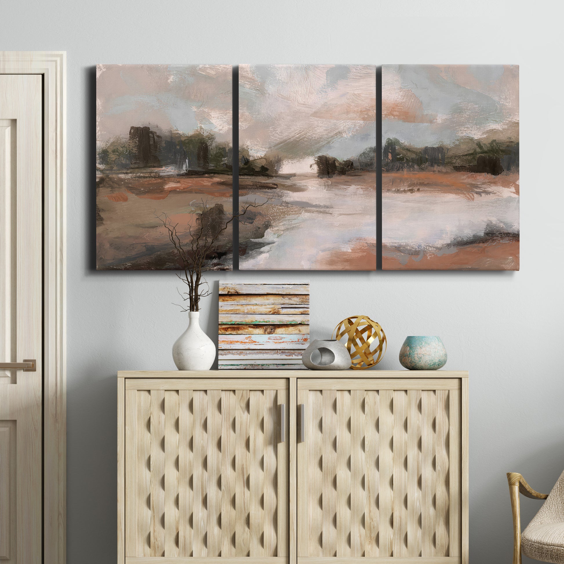 Three-panel canvas wall art featuring quiet pond with soft reflections, displayed above a cabinet in an entryway.