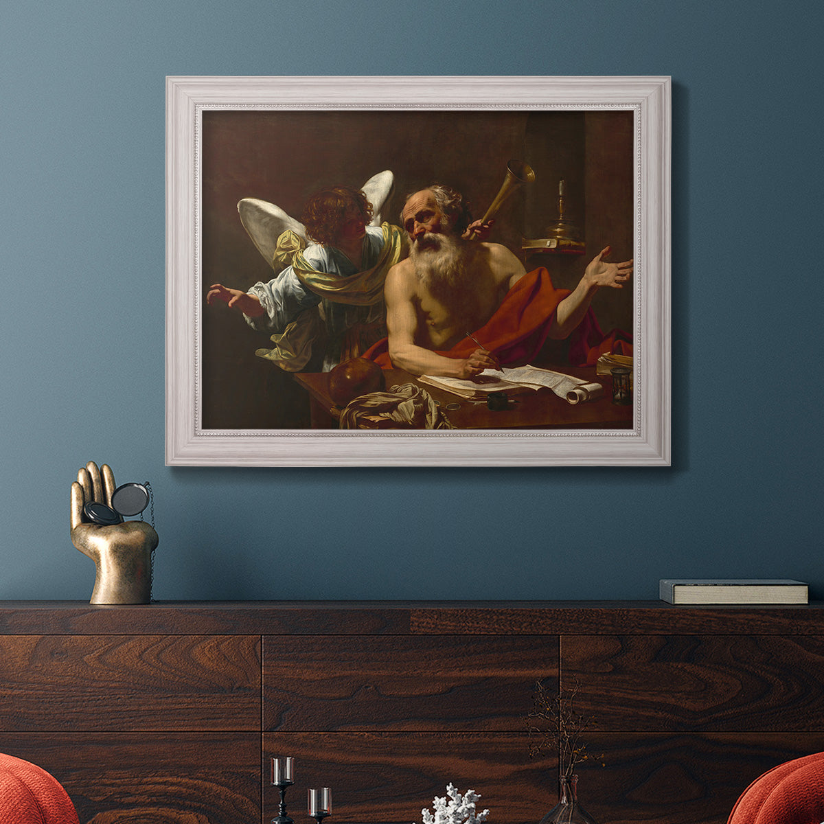 Classical religious painting of Saint Jerome with an angel by Simon Vouet in an ornate weathered white frame displayed in a dark-toned interior setting.