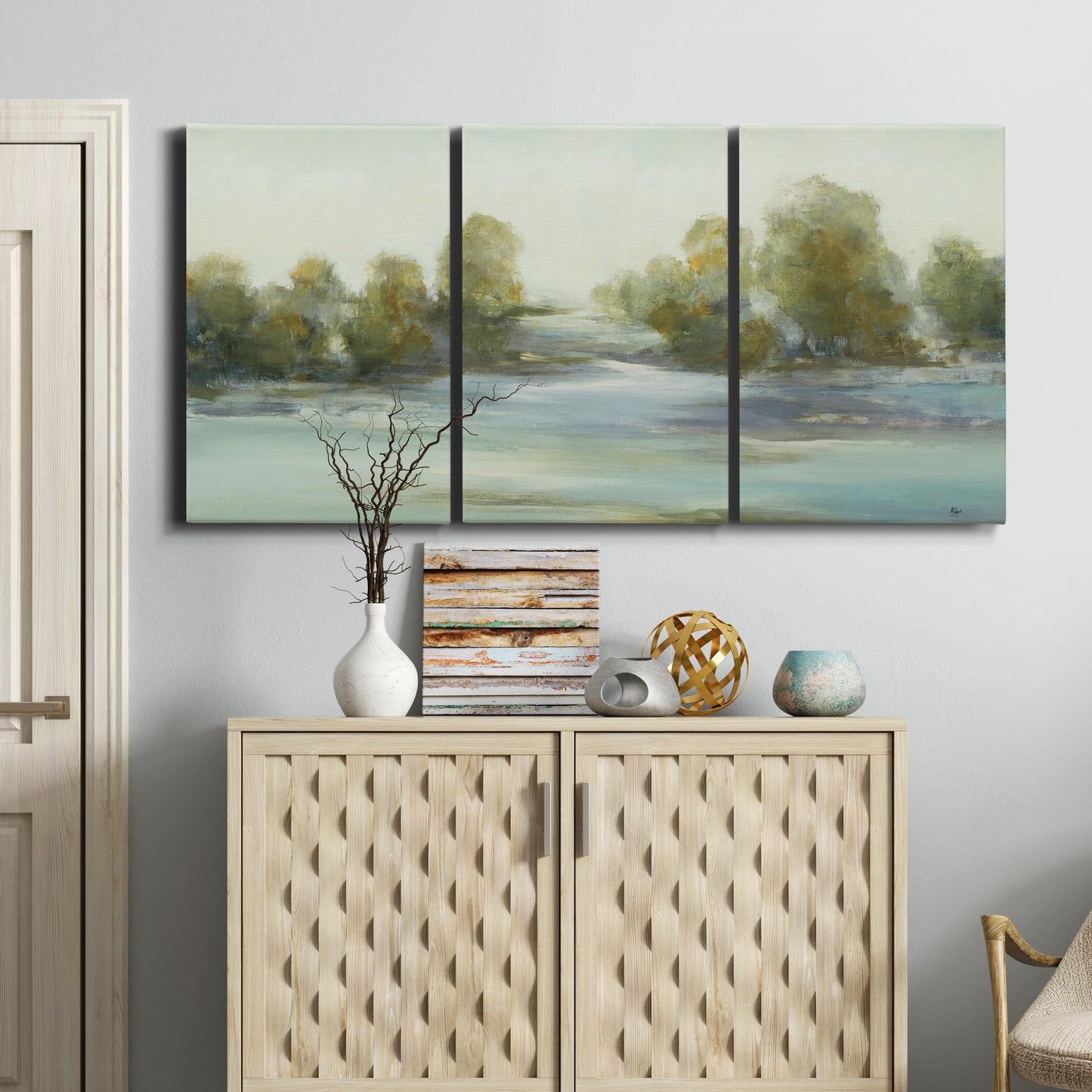 Three-panel canvas wall art featuring calming scenic landscape view, displayed above a cabinet in an entryway.