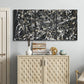 Three-panel canvas wall art featuring energetic expressionist abstract splatter, displayed above a cabinet in an entryway.