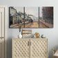 Three-panel canvas wall art featuring tree lined boulevard in town, displayed above a cabinet in an entryway.