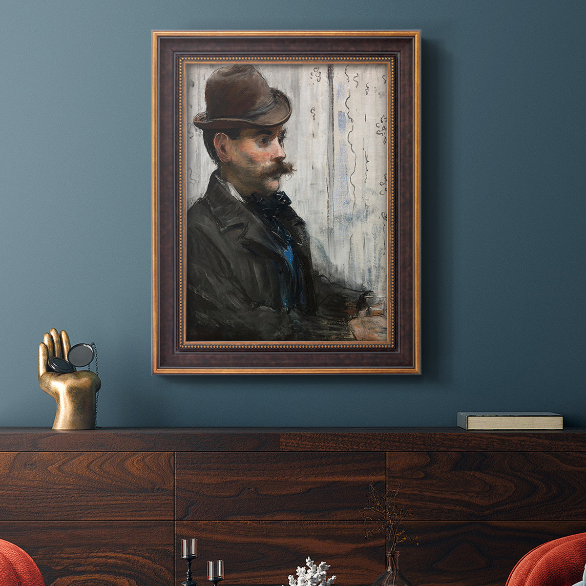 Impressionist portrait of a seated man by Édouard Manet in an ornate bronzed mahogany wood frame displayed in a dark-toned interior setting.