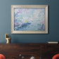 Impressionist industrial harbor scene by Paul Signac in an ornate champagne frame displayed in a dark-toned interior setting.