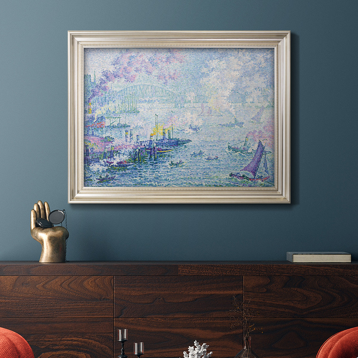 Impressionist industrial harbor scene by Paul Signac in an ornate champagne frame displayed in a dark-toned interior setting.
