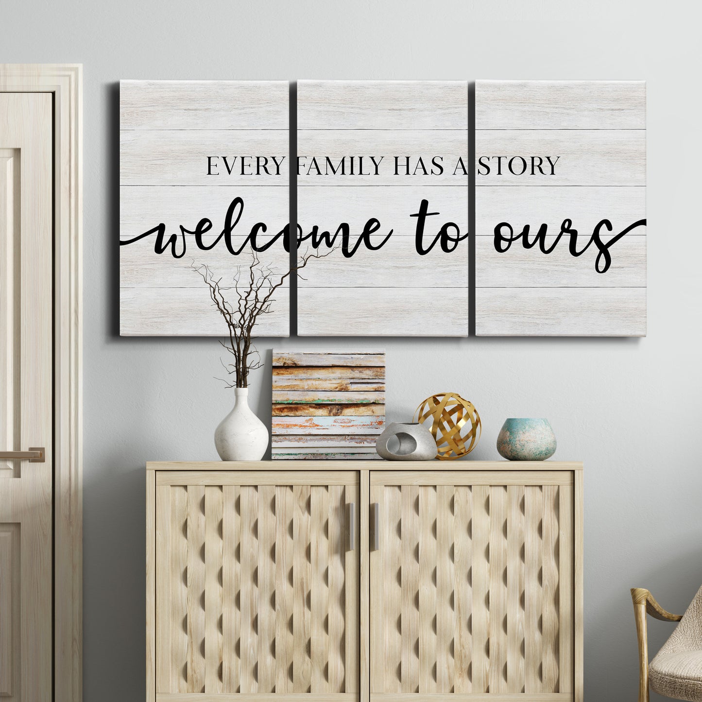 Three-panel canvas wall art featuring tropical beach at sunset photograph, displayed above a cabinet in an entryway.