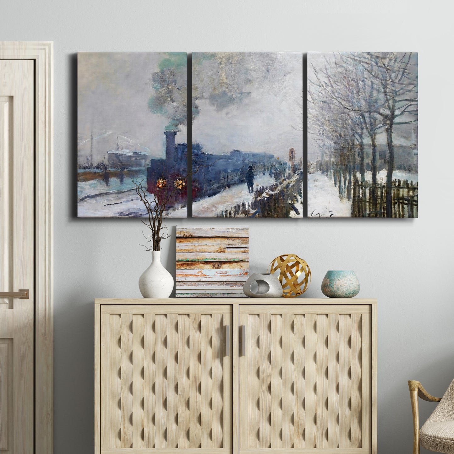 Three-panel canvas wall art featuring steam train in snowy landscape, displayed above a cabinet in an entryway.