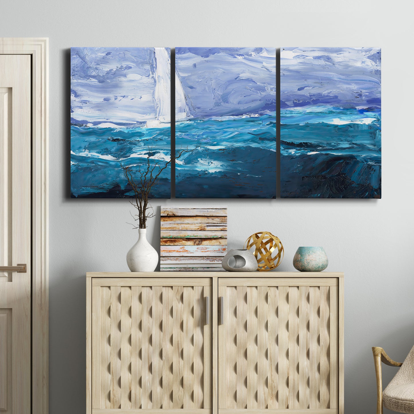 Three-panel canvas wall art featuring impressionist nautical harbor scene, displayed above a cabinet in an entryway.