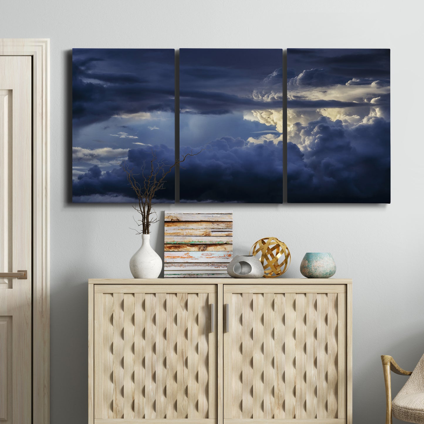 Three-panel canvas wall art featuring hot air balloons rising at dawn, displayed above a cabinet in an entryway.