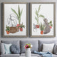 Set of two gray barnwood framed canvas prints depicting paired whimsical botanical animal illustrations with curious felines, terracotta pots, succulents, and leafy stems above a sofa in a contemporary living room.