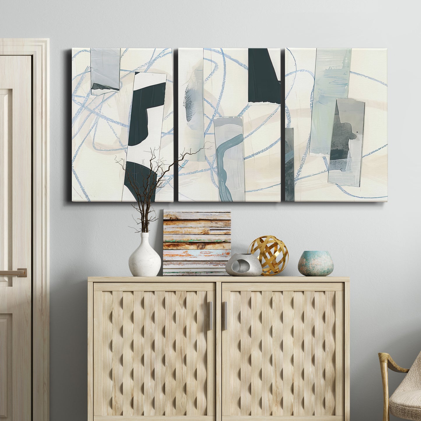 Three-panel canvas wall art featuring interwoven icy abstract linear forms, displayed above a cabinet in an entryway.