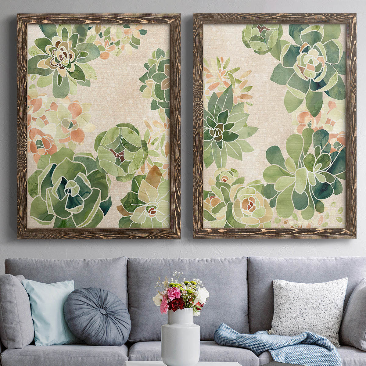 Set of two walnut barnwood framed canvas prints depicting paired decorative botanical pattern prints with green rosettes, peach blossoms, and mosaic-like outlines above a sofa in a contemporary living room.