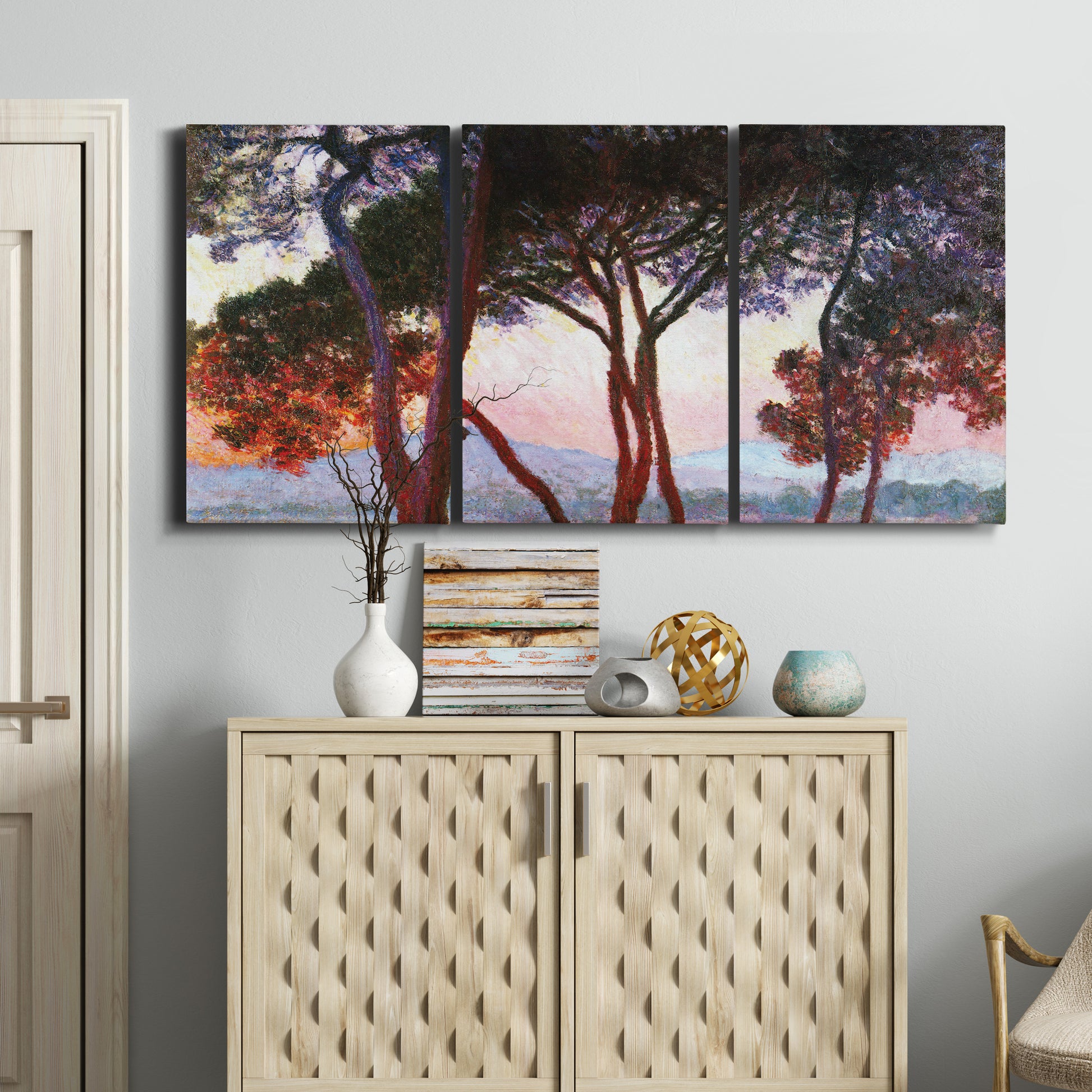 Three-panel canvas wall art featuring sunlit pines along mediterranean coast, displayed above a cabinet in an entryway.
