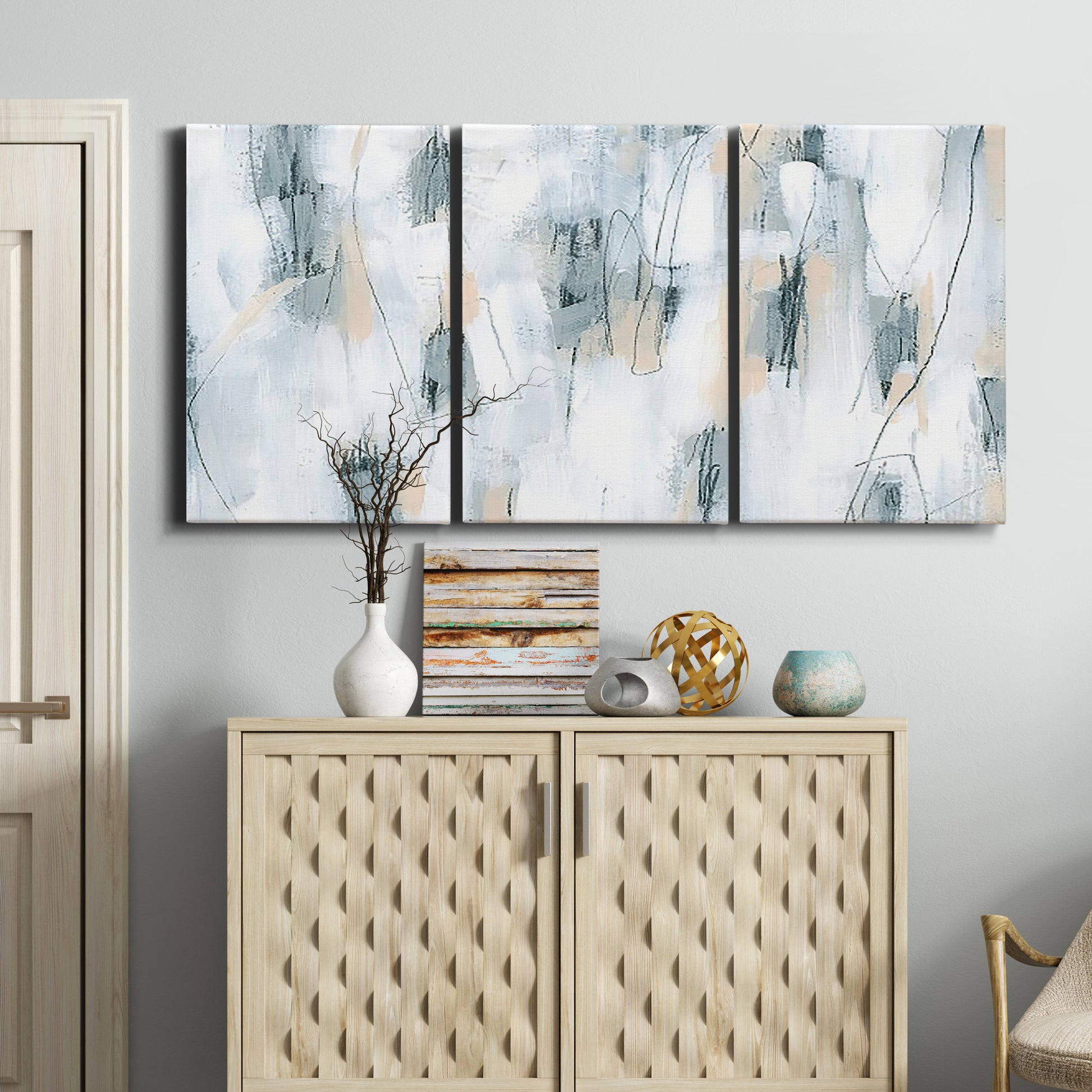Three-panel canvas wall art featuring industrial textured abstract hatch patterns, displayed above a cabinet in an entryway.