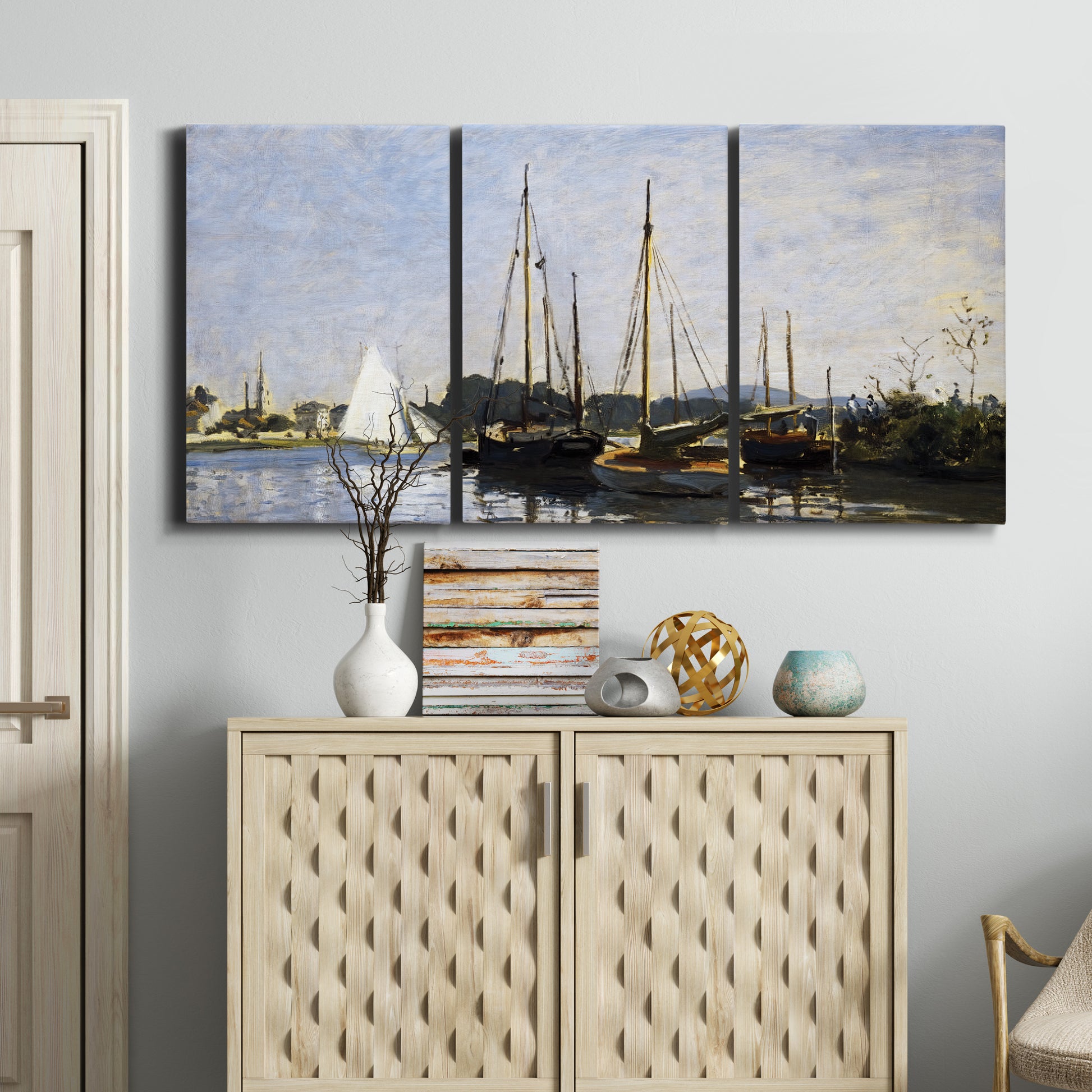 Three-panel canvas wall art featuring small pleasure boats on calm water, displayed above a cabinet in an entryway.