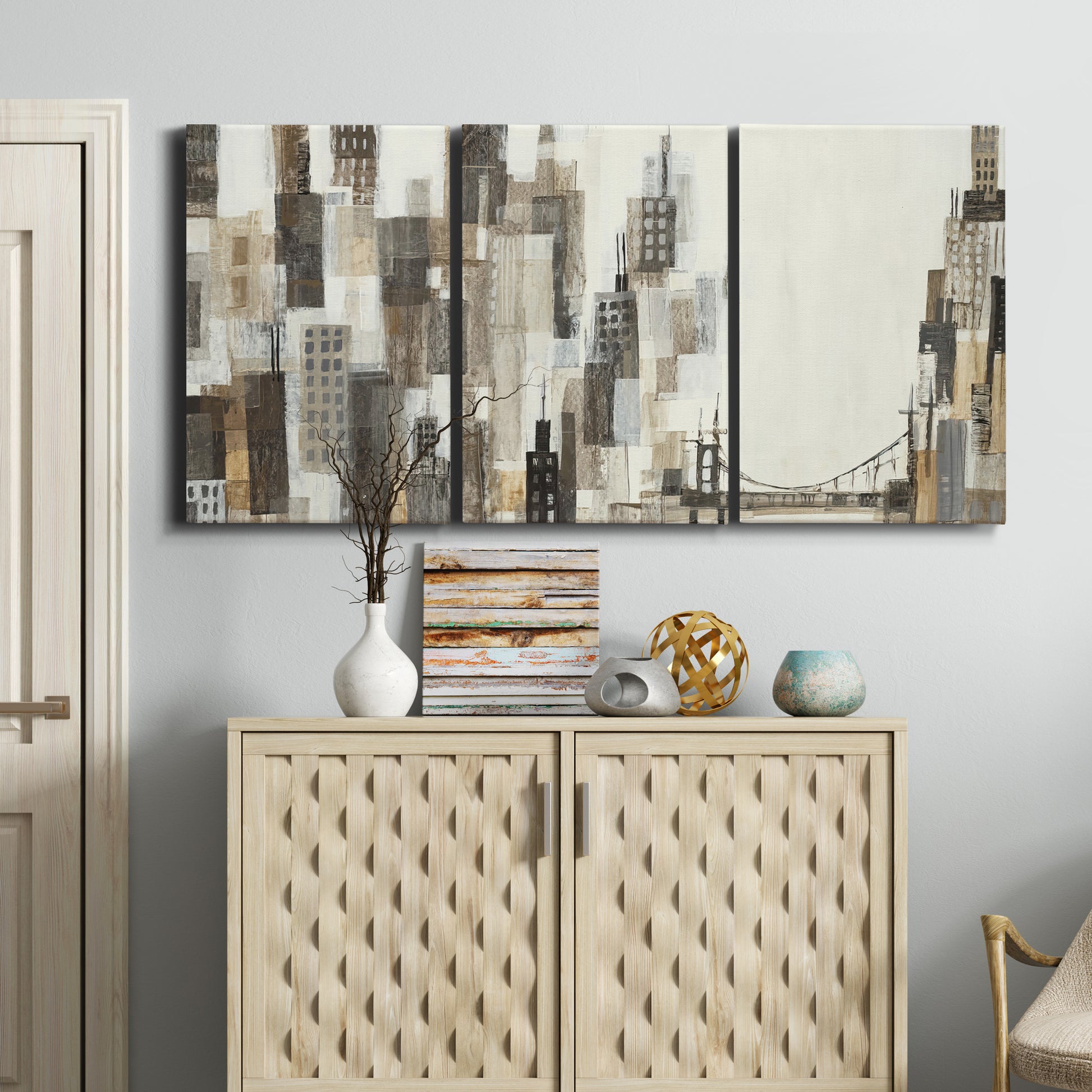 Three-panel canvas wall art featuring abstract harbor inspired composition, displayed above a cabinet in an entryway.