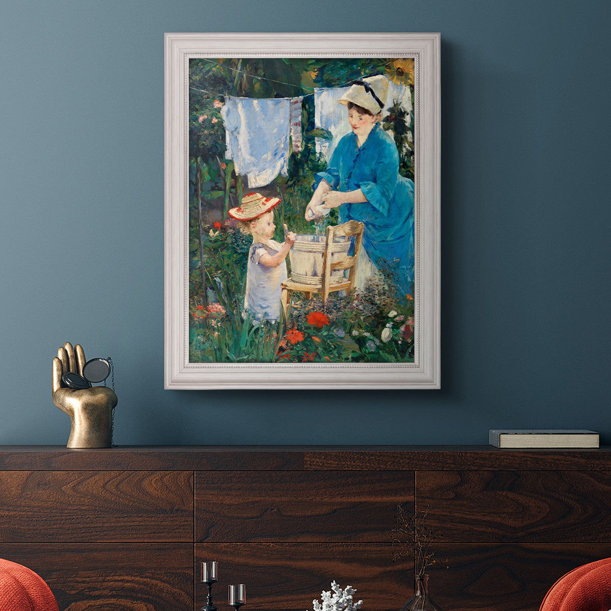Intimate domestic genre scene by Édouard Manet in an ornate weathered white frame displayed in a dark-toned interior setting.