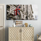 Three-panel canvas wall art featuring london street scene photograph, displayed above a cabinet in an entryway.